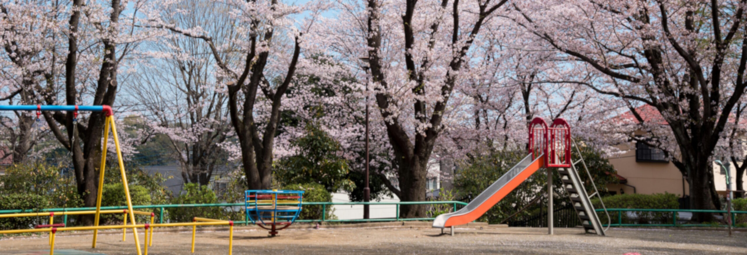 Empty playground in early spring, soft blur effect to reflect emotional tone of parenting blog post